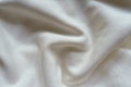 Rumpled white cotton jersey fabric from above