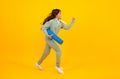 Run and jump. Teenage girl dressed in sports uniform, posing in the studio. Child in a posh stylish sports suit in a Royalty Free Stock Photo