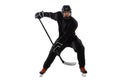 On the run. Male hockey player with the stick on ice court and white background. Royalty Free Stock Photo