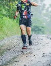 Run rain,Cross country runner,Trail running in the forest,uphill in autumn trail of mud and stones,In the north of Thailand,blur,S Royalty Free Stock Photo