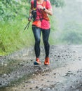 Run rain,Cross country runner,Trail running in the forest,uphill in autumn trail of mud and stones,In the north of Thailand,blur,S Royalty Free Stock Photo