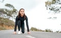 Run at your own pace. Full length shot of an attractive young woman crouched down in a starters position before