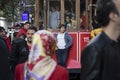 Runaway boarded passenger hanging behind historic red tram. Self-confident