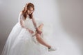 Runaway bride laces shoelaces. girl in a magnificent wedding dress and white sneakers