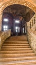Decaying staircase and hall of a former palazzo in Piacenza, Italy