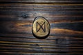 Rune Dagaz carved from wood on a wooden background Royalty Free Stock Photo