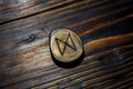 Rune Dagaz carved from wood on a wooden background Royalty Free Stock Photo