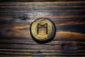 Rune Mannaz Mann carved from wood on a wooden background Royalty Free Stock Photo