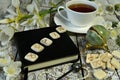 Runes on black diary book, crystal and cup of tea on witch table