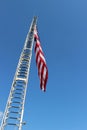 The rungs of a fireman's ladder and flag