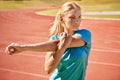 Runner, arms and woman stretching in stadium for race, marathon or competition training for health. Sports, fitness and Royalty Free Stock Photo