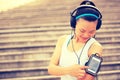 Runner athlete listening to music in headphones from smart phone mp3 player Royalty Free Stock Photo