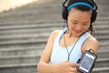 Runner athlete listening to music in headphones from smart phone mp3 player Royalty Free Stock Photo