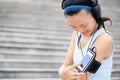 Runner athlete listening to music in headphones from smart phone mp3 player Royalty Free Stock Photo