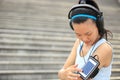 Runner athlete listening to music in headphones from smart phone mp3 player Royalty Free Stock Photo