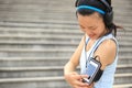 Runner athlete listening to music in headphones from smart phone mp3 player Royalty Free Stock Photo