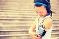 Runner athlete listening to music in headphones from smart phone mp3 player Royalty Free Stock Photo