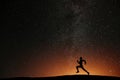 Runner athlete running on the hill with beautiful starry night