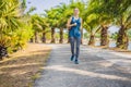 Runner athlete running at tropical park. woman fitness sunrise jogging workout wellness concept Royalty Free Stock Photo