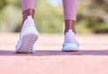Runner athlete, woman and feet on pavement with blurred background ready for fitness and exercise. Road, run shoes and Royalty Free Stock Photo