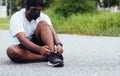 Runner black man wear face mask protective he shoelace trying running shoes Royalty Free Stock Photo