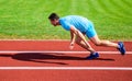 Runner captured in motion just after start of race. Runner sprint race at stadium. How to start running. Boost speed