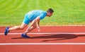 Runner captured in motion just after start of race. Runner sprint race at stadium. How to start running. Boost speed Royalty Free Stock Photo