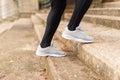 Runner climbing the stairs. Detail of the feet. Unrecognizable.