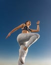 Runner concept. Jogging run. Strong athletic woman jumping on sky background wearing in the sportswear. Fitness and Royalty Free Stock Photo