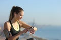 Runner with earbuds checking music on smartwatch Royalty Free Stock Photo