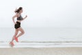 Runner feet running outdoor on the beach. Asian fitness and sporty woman running for healthy Royalty Free Stock Photo