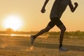 Runner feet running on road closeup on shoe. man fitness sunrise jog workout welness concept