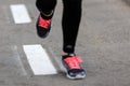 Runner feet running on road closeup on shoe. Royalty Free Stock Photo