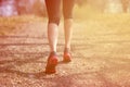 Runner feet running on road closeup on shoe. woman fitness sunrise jog workout welness concept. Royalty Free Stock Photo
