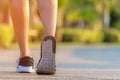 Runner feet running on the road in the outdoor workout park, closeup on shoe. Asian fitness woman running for healthy and relax. Royalty Free Stock Photo