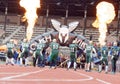 Runner and football players in the Tough Viking Event