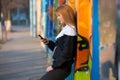 Runner girl resting with mobile phone on the street Royalty Free Stock Photo