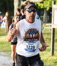 Runner gives thumbs up during 5K trail race at Belmont Lake State Park