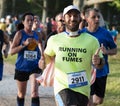 Runner gives two thumbs up during 5K race in a park