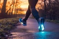 runner with glowing sneakers on predawn path