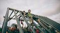 Runner going down structure in a test of extreme obstacle race