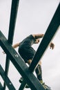 Runner going down wall in a test of extreme obstacle race