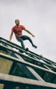 Runner going down wall in a test of extreme obstacle race