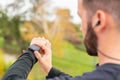 Runner with headphones checking stopwatch. Detail. Unrecognizable.