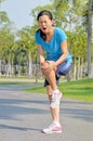 Runner hold her sports injured knee