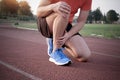 Runner with injured knee on the track Royalty Free Stock Photo