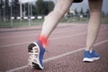 Runner with injured knee on the track Royalty Free Stock Photo