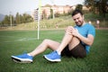 Runner with injured knee on the track Royalty Free Stock Photo