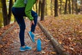 Runner injured leg during workout exercises in autumn park. Woman feels ankle pain and crick Royalty Free Stock Photo