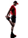 Runner jogger stretching warming up silhouette Royalty Free Stock Photo